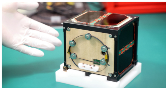 The world’s first wooden satellite made from wood and named LignoSat, developed by scientists at Kyoto University and logging company Sumitomo Forestry, is shown during a press conference at Kyoto University in Kyoto on May 28, 2024